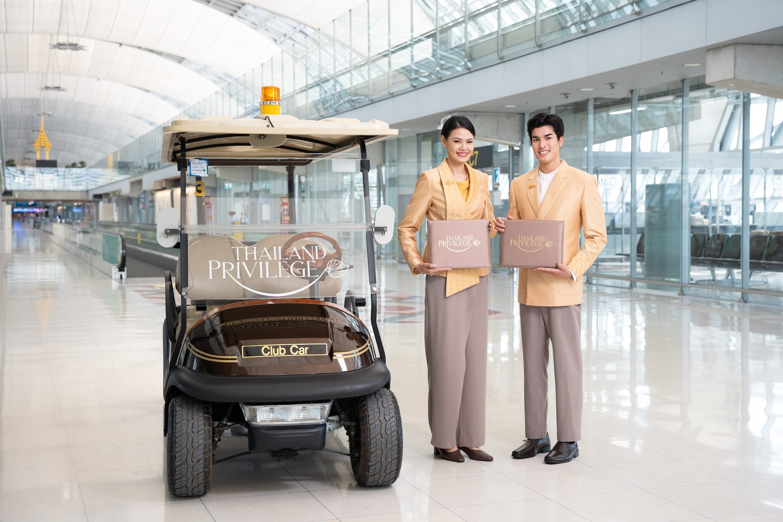 Thailand Privilege Elite Personal Assistants greeting members at Suvarnabhumi Airport with a Privilege-branded electric cart