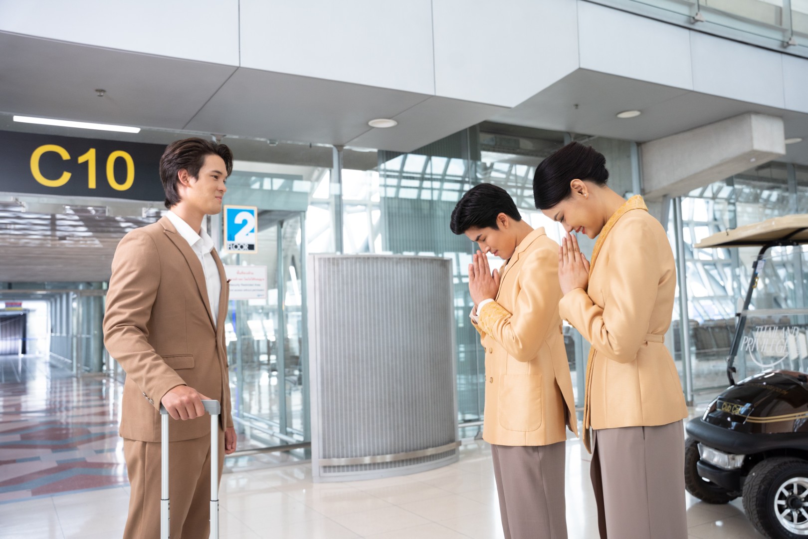 Thailand Privilege Elite Personal Assistants greeting a member with a traditional Thai wai at the Suvarnabhumi airport arrival gate