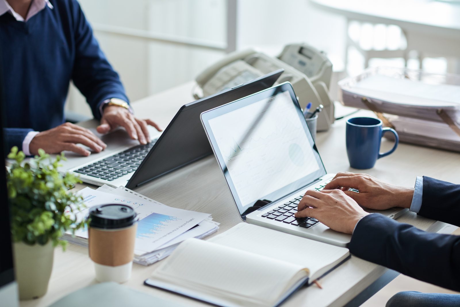 Business professionals on laptops — Can I work on Thailand Privilege Visa, residency vs work permit explained